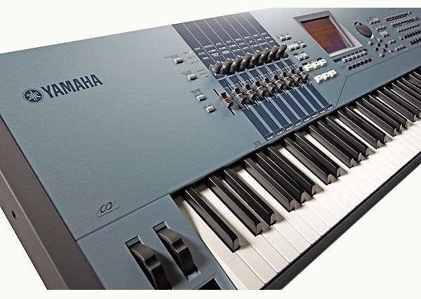 A Yamaha Motif XS workstation in dolphin blue, showing the control panel, sliders, and keys.